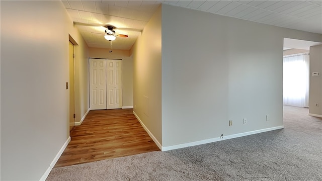 corridor with hardwood / wood-style flooring