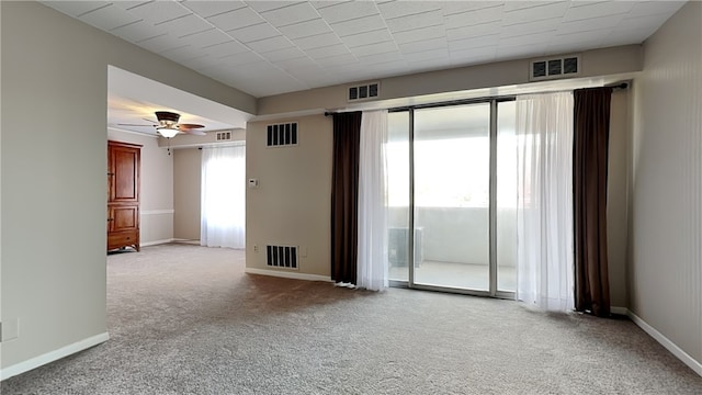 carpeted spare room with a healthy amount of sunlight and ceiling fan