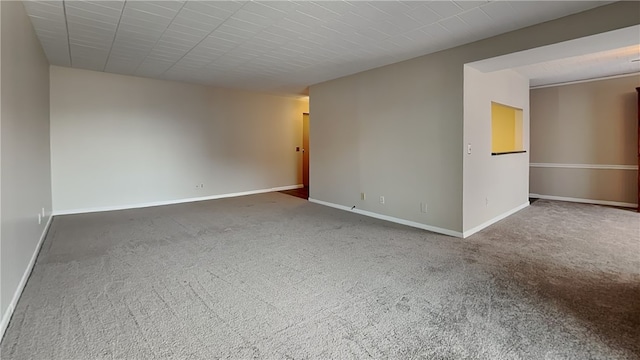 unfurnished room with dark colored carpet