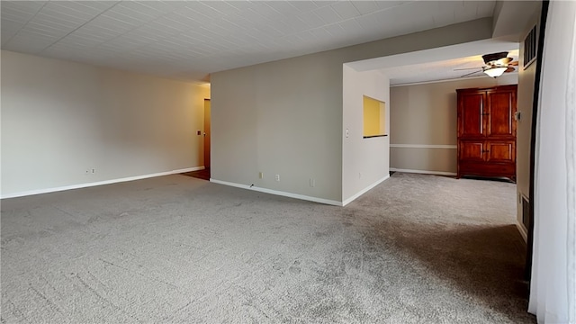 empty room featuring ceiling fan and carpet flooring