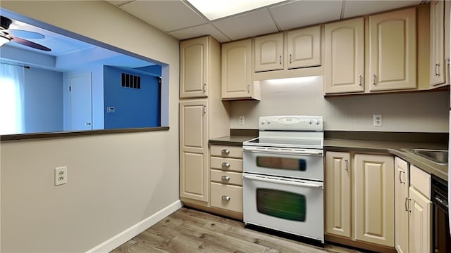 kitchen with white electric range oven, a paneled ceiling, sink, light hardwood / wood-style floors, and ceiling fan