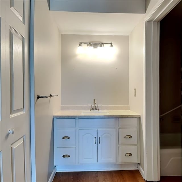 bathroom featuring hardwood / wood-style flooring and vanity