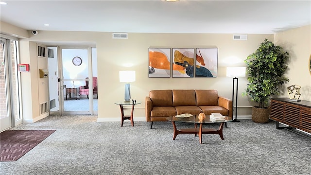 living room with carpet and a healthy amount of sunlight