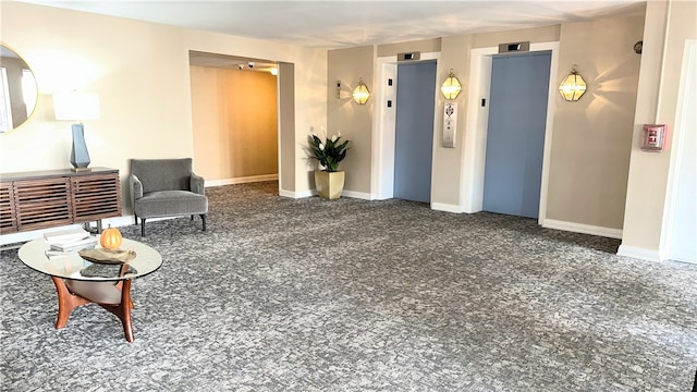 sitting room featuring elevator and dark carpet