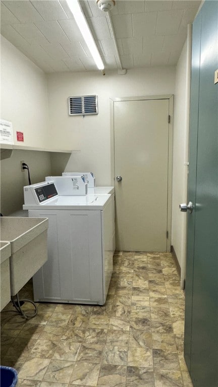 laundry area with sink and separate washer and dryer