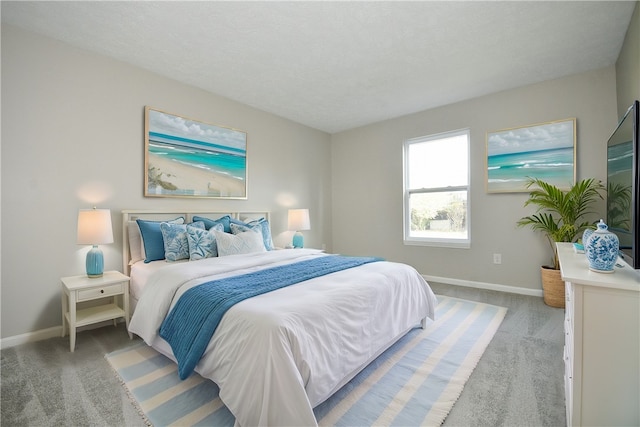 bedroom featuring a textured ceiling and light carpet