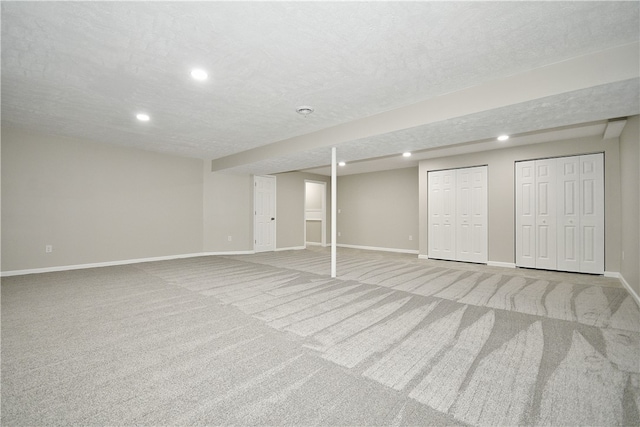 basement with carpet and a textured ceiling