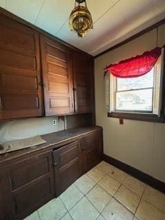 kitchen featuring light tile patterned floors and tile counters