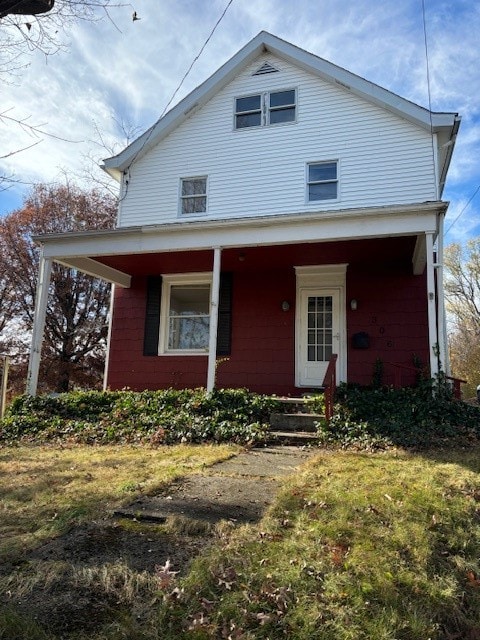 view of front of house with a front yard and covered porch