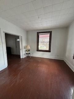 spare room with dark wood-type flooring