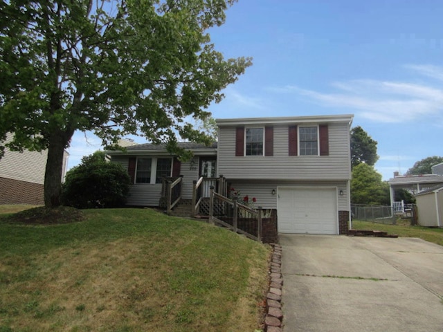 tri-level home featuring a garage and a front lawn