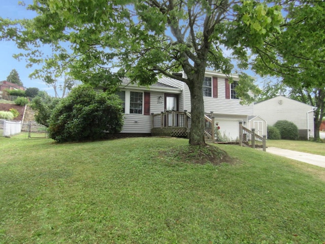 split level home featuring a front lawn and a garage