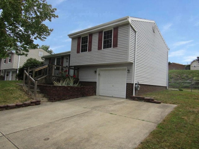 205 Wheatfield Dr, Hempfield Twp Wml, PA 15601 - split level home featuring an attached garage, concrete driveway, and a deck