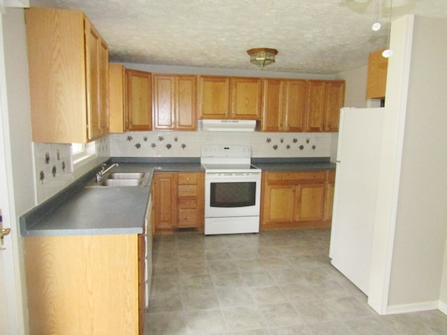 kitchen with a textured ceiling, tasteful backsplash, sink, and white appliances