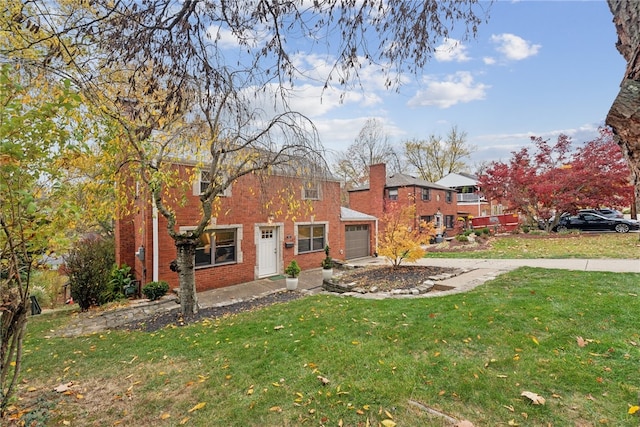 view of front of property with a front lawn and a garage