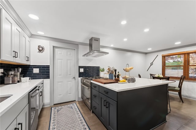 kitchen featuring tasteful backsplash, extractor fan, stainless steel appliances, and white cabinets