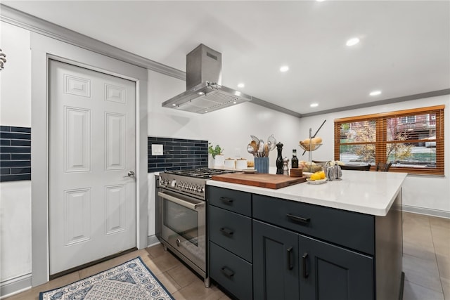 kitchen with island exhaust hood, crown molding, backsplash, stainless steel stove, and light tile patterned floors