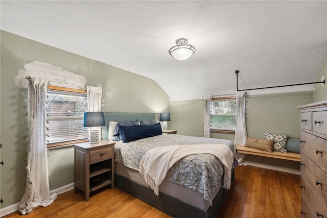 bedroom featuring lofted ceiling and hardwood / wood-style floors