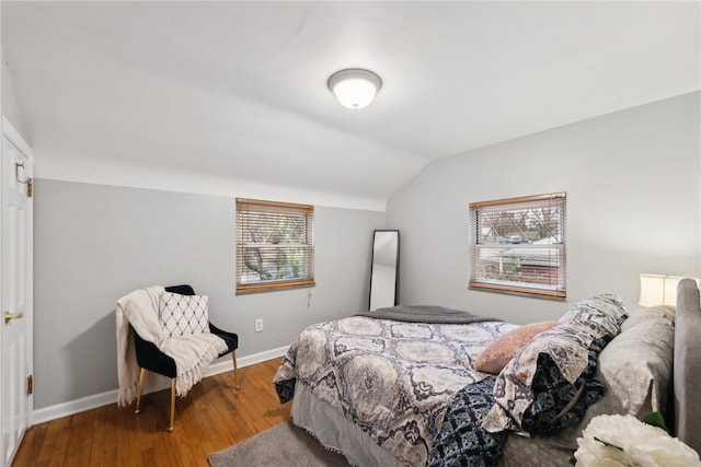 bedroom featuring hardwood / wood-style floors and vaulted ceiling