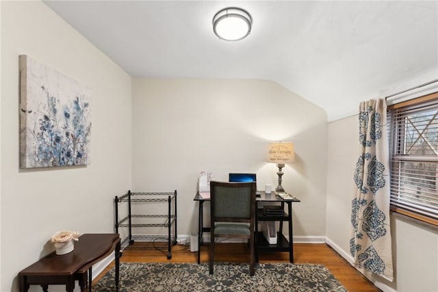 living area with hardwood / wood-style floors and lofted ceiling