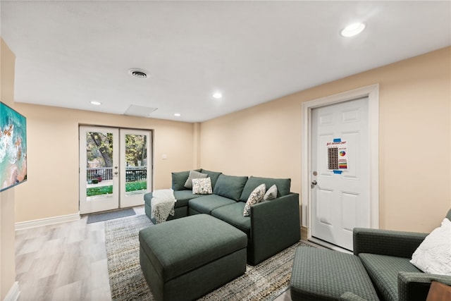 living room with french doors and light hardwood / wood-style flooring