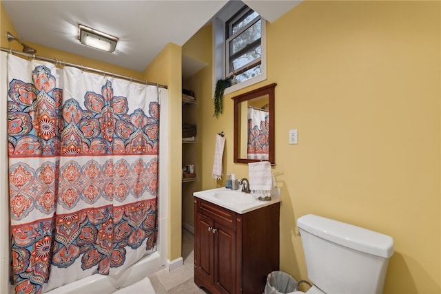 bathroom featuring toilet, vanity, and curtained shower