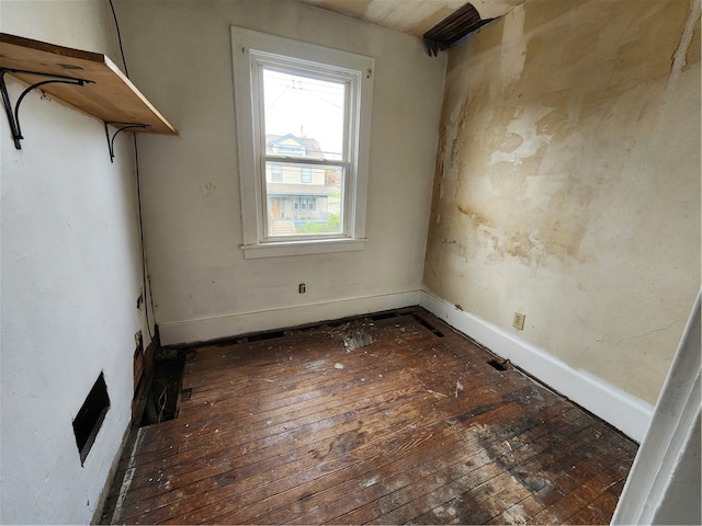 empty room featuring dark hardwood / wood-style flooring