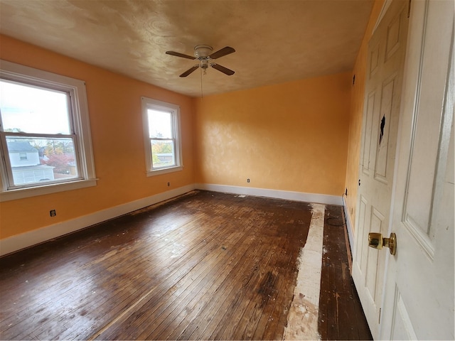 spare room featuring dark wood-type flooring and ceiling fan