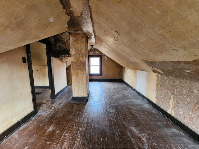 additional living space with lofted ceiling and dark hardwood / wood-style floors