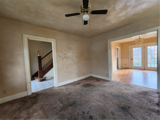 carpeted spare room with ceiling fan and a textured ceiling