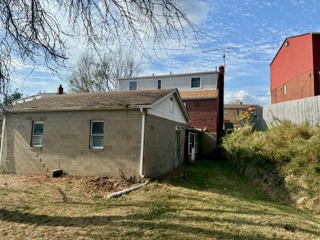 back of property featuring a lawn