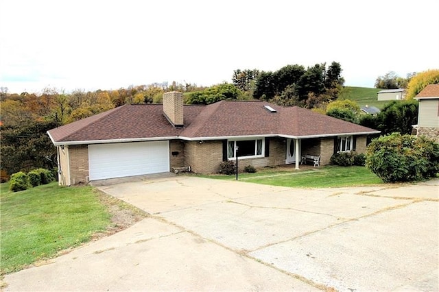 ranch-style house featuring a front lawn and a garage