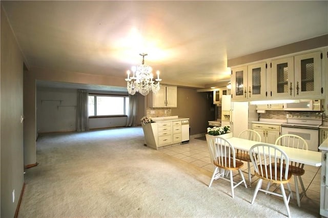 kitchen featuring a chandelier, light tile patterned flooring, white cabinetry, white appliances, and decorative light fixtures