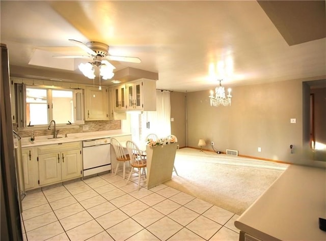 kitchen featuring light carpet, sink, white cabinets, dishwasher, and ceiling fan with notable chandelier