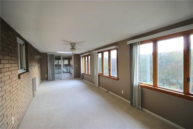 interior space with light colored carpet and ceiling fan