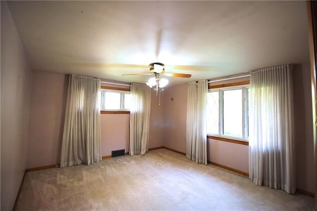 carpeted spare room with ceiling fan