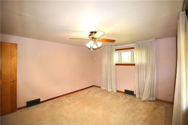 carpeted spare room featuring ceiling fan