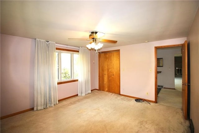 empty room featuring light colored carpet and ceiling fan