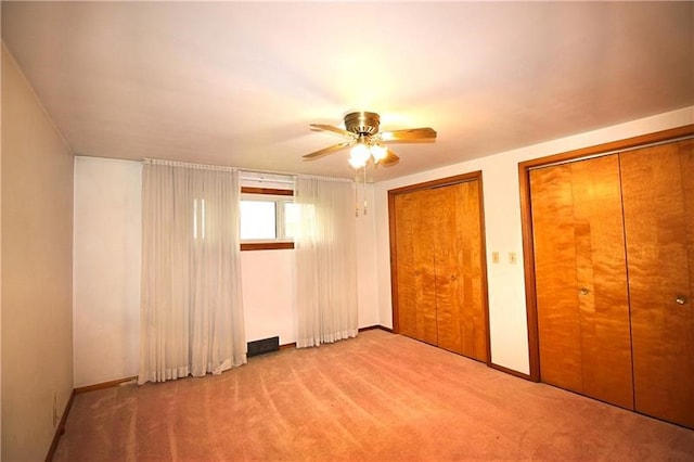 219 Ball Hill Rd, German Twp, PA 15410 - unfurnished bedroom with two closets, carpet flooring, ceiling fan, and baseboards