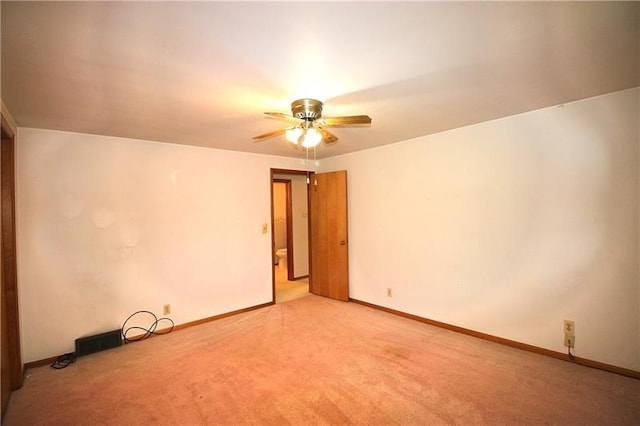 unfurnished room featuring light carpet and ceiling fan