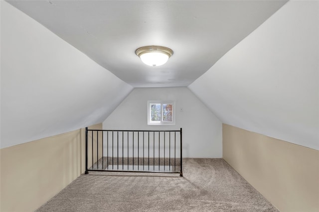 bonus room with lofted ceiling and carpet