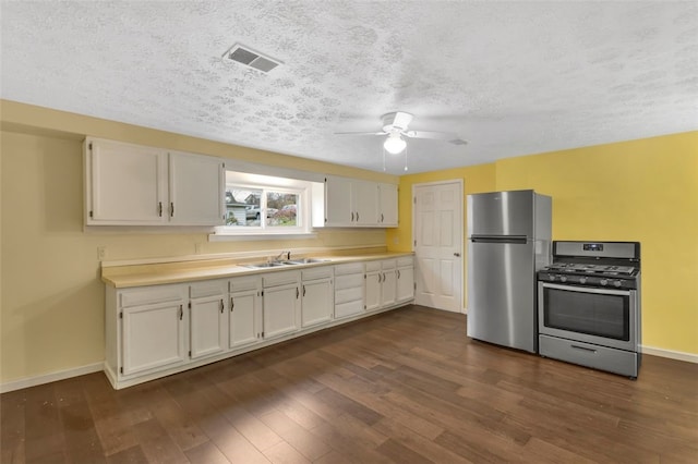 kitchen with white cabinetry, sink, dark hardwood / wood-style floors, and stainless steel appliances