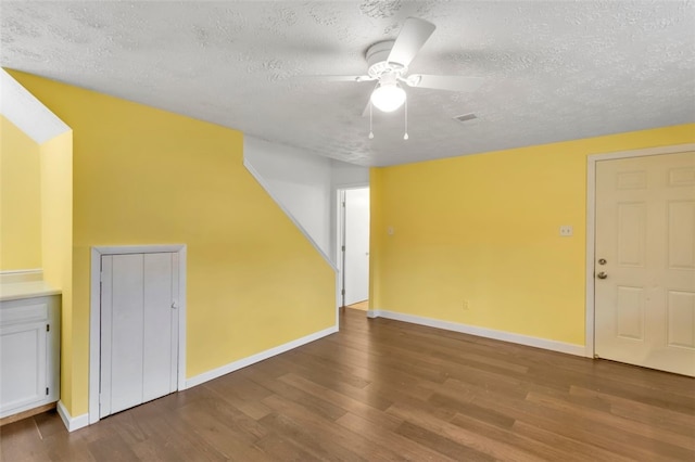 interior space with wood-type flooring, a textured ceiling, and ceiling fan