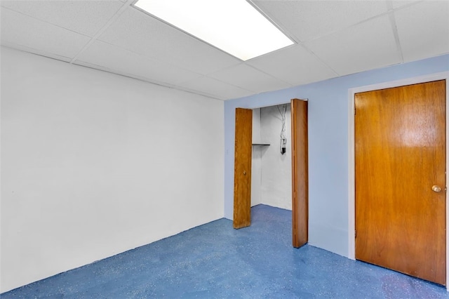 interior space with a paneled ceiling