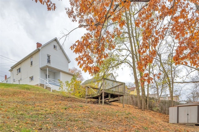 view of yard featuring a storage shed and a deck