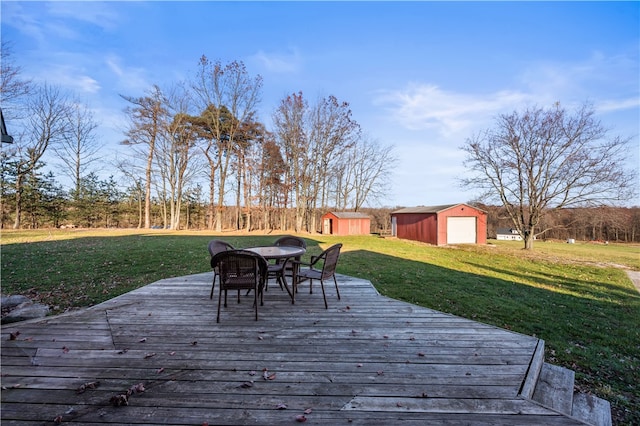 wooden terrace featuring a yard and a storage shed