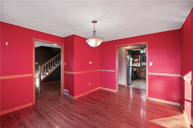 unfurnished dining area featuring wood-type flooring and ceiling fan