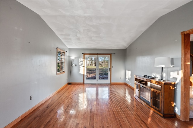 unfurnished living room with lofted ceiling and hardwood / wood-style flooring