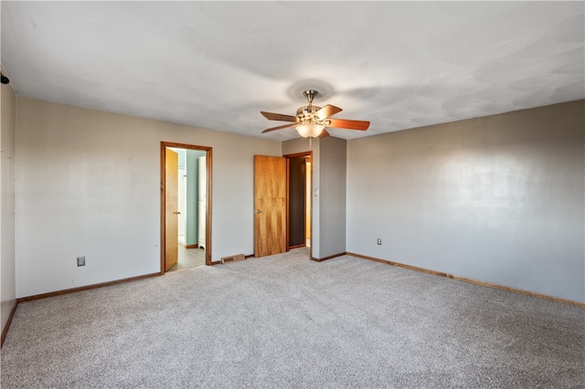 empty room with ceiling fan and light carpet