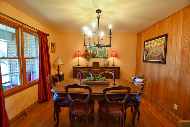 532 W Sunbury Rd, Center Twp But, PA 16001 - dining room featuring hardwood / wood-style floors, wooden walls, and an inviting chandelier